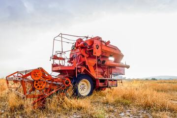 Abandoned tractor or harvester machine in the field.