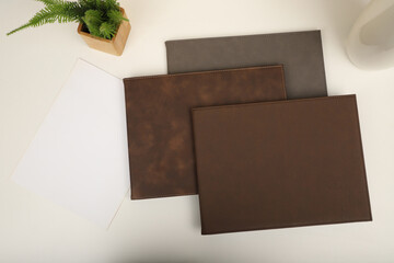 Colorful leather diploma holder. Concept shot, top view, different color, clamshell and stitched...