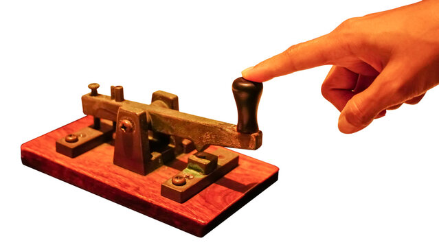 Close up of a telegraph key being used by an operator to make morse code and communicate, isolate on white background.
