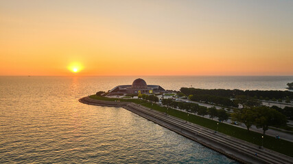 Adler Planetarium with sunrise over Lake Michigan coast in summer aerial, Chicago, IL