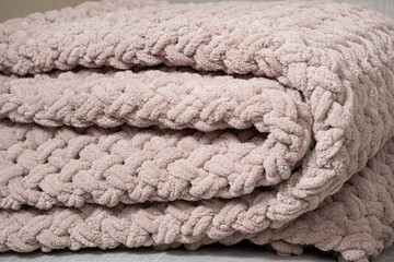 Knitted light pink plaid handmade close-up.