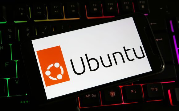 Viersen, Germany - December 9. 2023: Closeup of smartphone on computer keyboard with logo lettering of Ubuntu