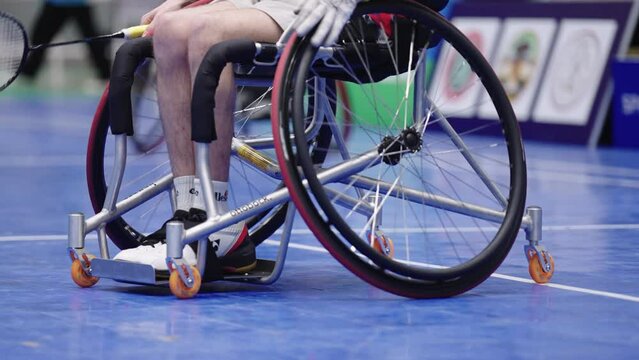 Take a video from behind Enjoy life Asian male sits in a competitive wheelchair preparation before a match training badminton