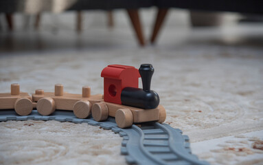 A close up of a multi-colored train toy on the floor