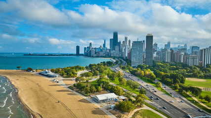 Sandy beach coast aerial with Chicago downtown skyscrapers and Lake Michigan, tourism