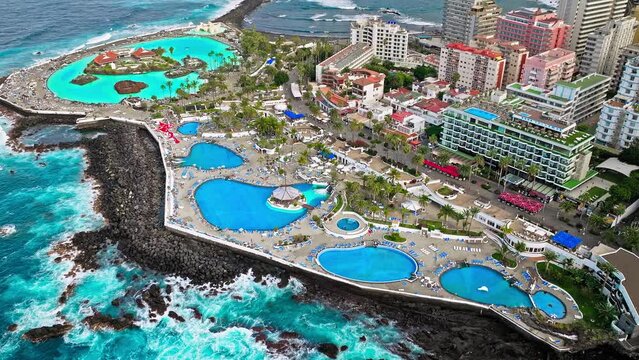 Aerial view of Lago Martiánez swimming pool, resort complex, and luxury hotels in Tenerife. Vacation destination in Puerto de la Cruz on the Canary Islands, Spain with terraces and restaurants.