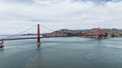 panoramic aerial landscape view of San Francisco Bay Area with Golden Gate Bridge in front, and Golden Gate National Recreation Area on right side of bridge