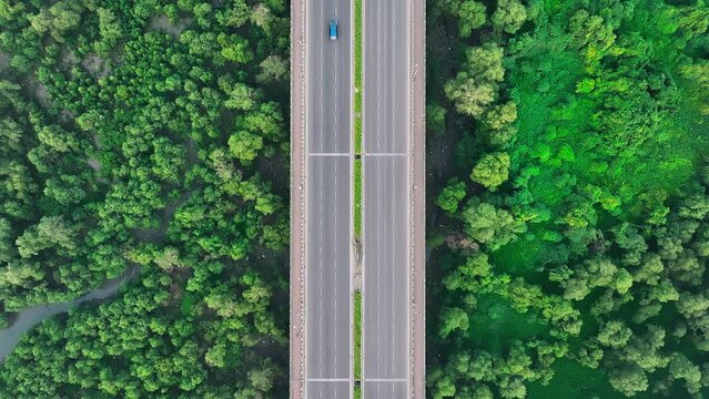 Aerial topdown view of vehicles travelling on Airoli motor bridge that connects Mumbai to Navi Mumbai over mangroves, creek. Drone view of bridge connecting cities over river in India.