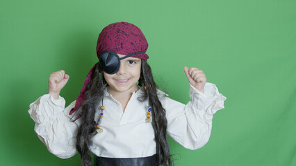 Adorable kid pirate with long hair and eye patch pissing with angry pirate face over green...