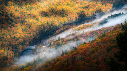 Wonderful Jacques-Cartier river national park and Autumn's colorful foliage, surrounded by fog, QC, Canada