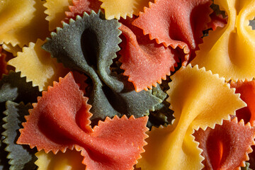 Uncooked Vibrant Colored Farfalle Pasta: A Culinary Canvas of Multicolored Bow-Tie Macaroni,...