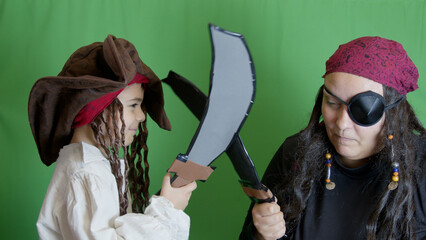 Pirates getting angry and fighting with cutlasses. Isolated on green background,. High quality photo