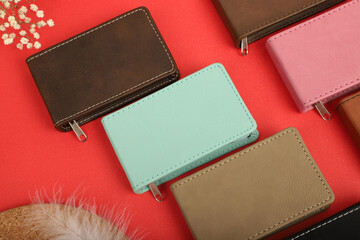 Manicure set kit in Colorful leather case. Concept shot, top view, different colors Manicure set. Special background Manicure set view. Red background.