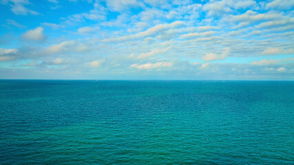 Blue sky with white clouds over blue green water aerial of Lake Michigan, dream, inspiration
