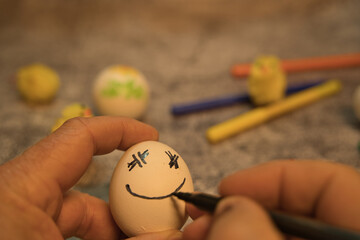 Boiled egg gets a face painted for Easter