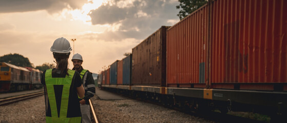Foreman checking inventory or task details on freight train cars and shipping containers. Logistics...