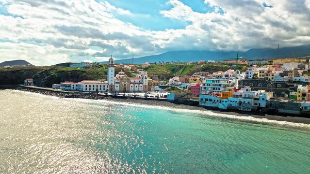 Aerial view of Roman Catholic Spanish Church and colourful houses, and hotels in the Canary Islands, Spain. View from above of Basilica of Our Lady of Candelaria by the seashore in Tenerife. 