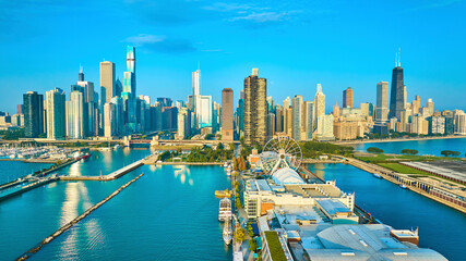 Navy Pier on Lake Michigan aerial of Chicago, IL city skyscrapers with sunny dawn - Powered by Adobe