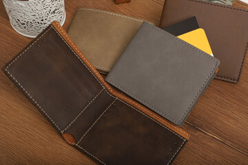 Colorful man wallet. Concept shot, top view, different colors man wallet. Special wooden background man wallet view. Men fashion and accessories.