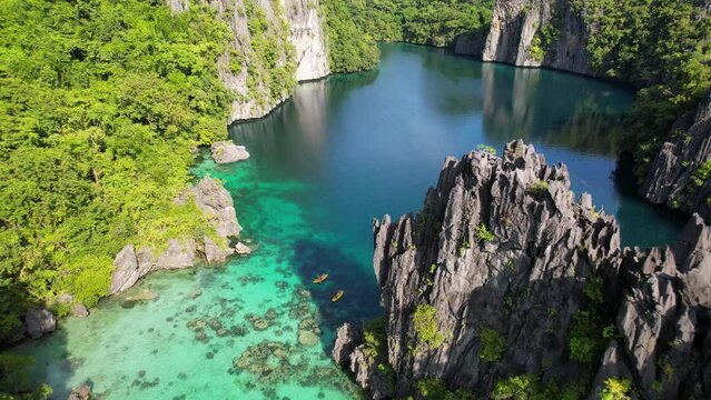Aerial footage of kayakers exploring tropical islands in the Philippines 