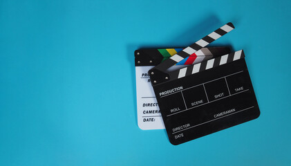Two clapper board on blue or carpi color background.