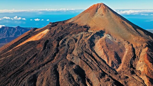 Aerial view of Mount Teide active volcano in Tenerife, Canary Islands. View from above the highest peak mountain with a scenic aerial cable car and hiking trails in Tenerife, Spain.