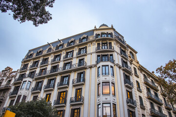 Fototapeta na wymiar Historical building on Rambla street cityscape image. Bottom street view at sunset time in Barcelona