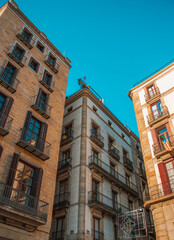 Fototapeta premium Empty street at sunset time in Barcelona, Spain photo. Historical building on Rambla street cityscape image