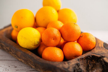 Mandarins in a rustic wooden dish, a delicious source of citrus vitamins