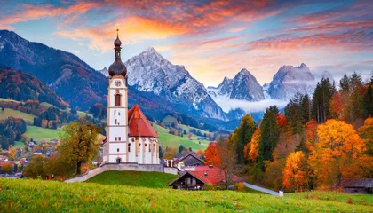 Fotobehang iconic picture of bavaria with maria gern church with hochkalter peak on background fantastic autumn sunrise in alps superb evening landscape of germany countryside traveling concept background © Raegan