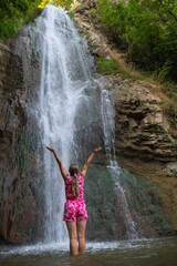 Cascading Dreams: Girl in Red Robes near the Waterfall