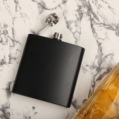 Black colors stainless flask. Concept shot, top view. Custom background flask view. Flask and accessories.
