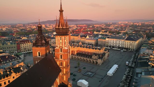krakow old town church aerial view drone at sunrise dawn flying to city market square