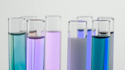 Close up shot of laboratory glassware on white background. Test tubes with colorful liquids in laboratory, scientific expertise.