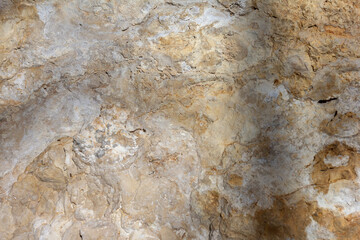 the wall of a mountain canyon made of natural material, stone - limestone material of volcanic origin, close-up.