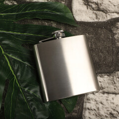 Silver colors stainless flask. Concept shot, top view. Custom background flask view. Flask and accessories.