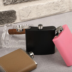 Diffirent colors stainless flask. Concept shot, top view. Custom background flask view. Flask and accessories.