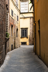 Fototapeta na wymiar the old street of the old town of Lucca with the medieval architecture. Tuscany