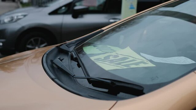 Car with Sale inscription on the glass, close-up. Sale of new and used cars