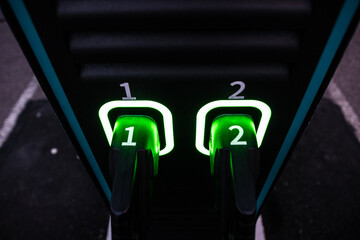 Two charging handles of an electric car charger.