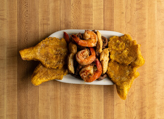 Grilled beef, chicken and shrimp with fried plantains