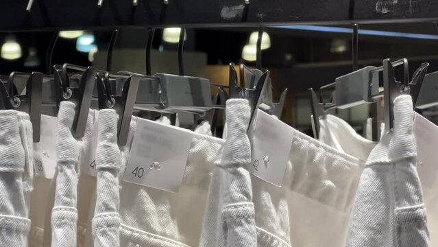 White denim jeans hanging in a clothing store window