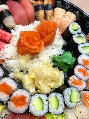 Sushi and rolls on a round plate