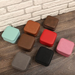 Diffirent colors leather jewelry box. Concept shot, top view. Custom background jewelry box view. Jewelry box and accessories.