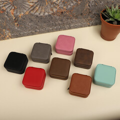 Diffirent colors leather jewelry box. Concept shot, top view. Custom background jewelry box view. Jewelry box and accessories.