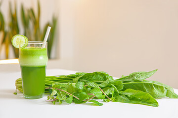 Vegetarian green spinach leaves, cucumber smoothie in glass isolated on white background