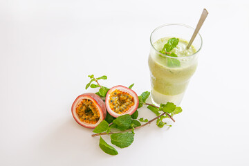 Vegetarian passion fruit and mint leaves smoothie in glass isolated on white background
