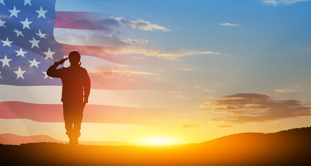 Silhouette of soldier saluting on background of sunset or sunrise and USA flag. Greeting card for...
