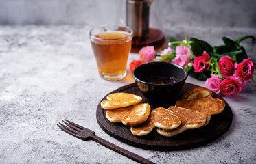 Pancakes with strawberry jam in the form of heart for Valentine's day holiday