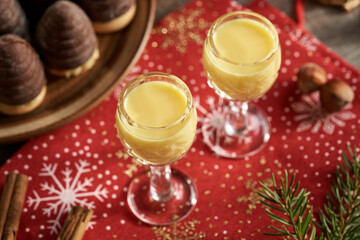 Two glasses of eggnog with Christmas cookies
